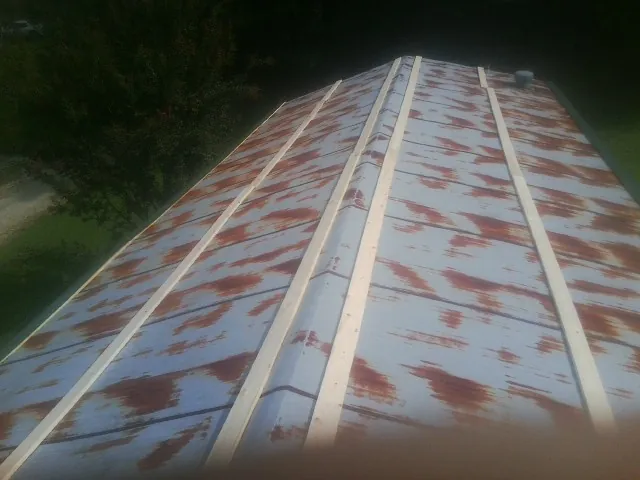 Rusted metal roof panels with new wood purlins before replacement — Storm Damage Roof Repair in Chiloquin by Roofing Brothers
